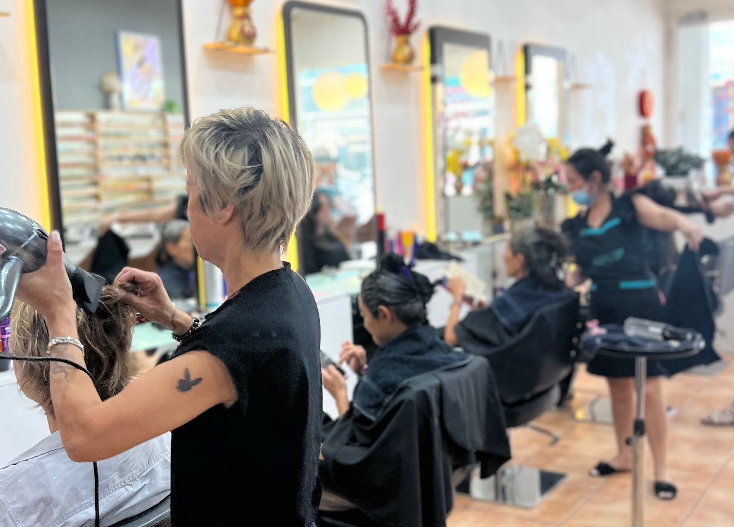Stylists busy at Jade Top Nails Hair Beauty Salon in Melbourne, Victoria, AU. Hair drying and styling in process.