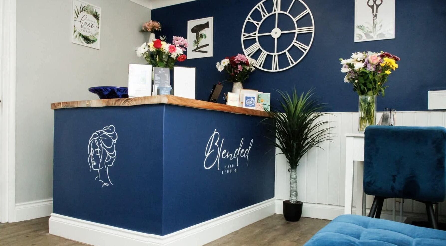 Welcome desk at Blended Hair Studio in Dereham, England, GB, showcasing chic décor and vibrant flowers.