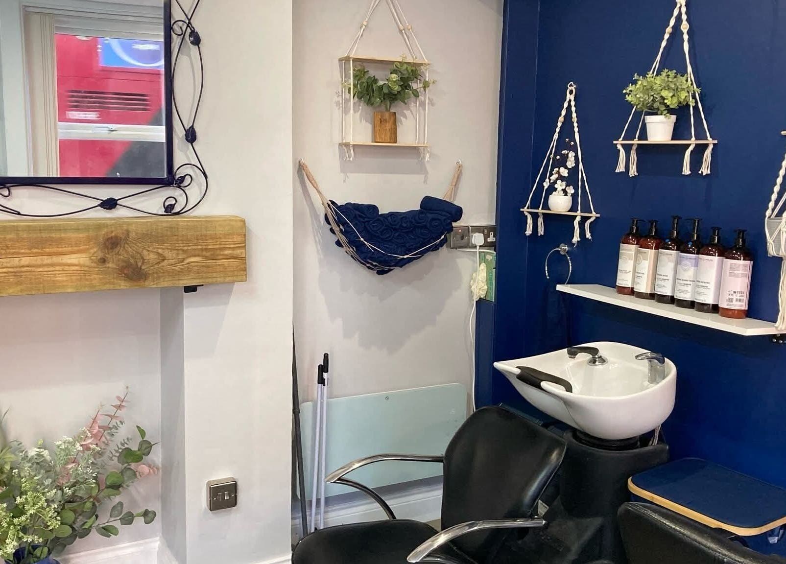 Elegant interior of Blended Hair Studio in Dereham, England showcasing stylish furnishings and modern decor.