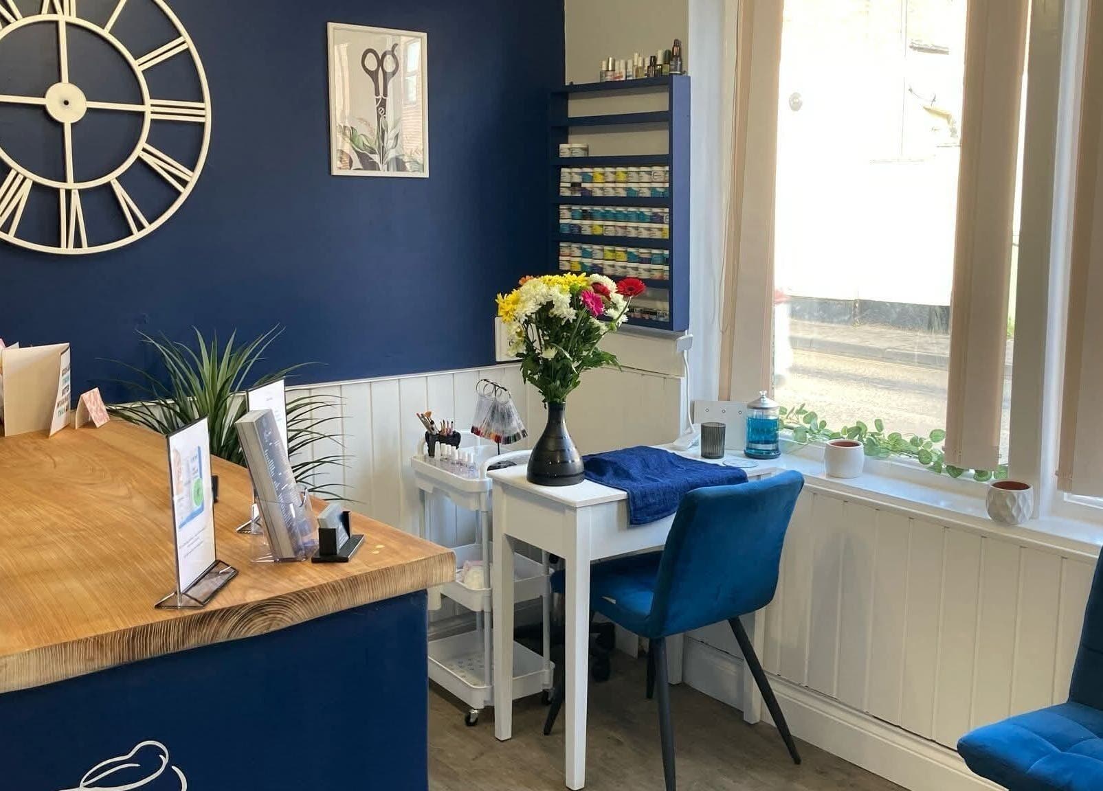 Chic interior of Blended Hair Studio in Dereham, England, featuring stylish decor and vibrant flowers.