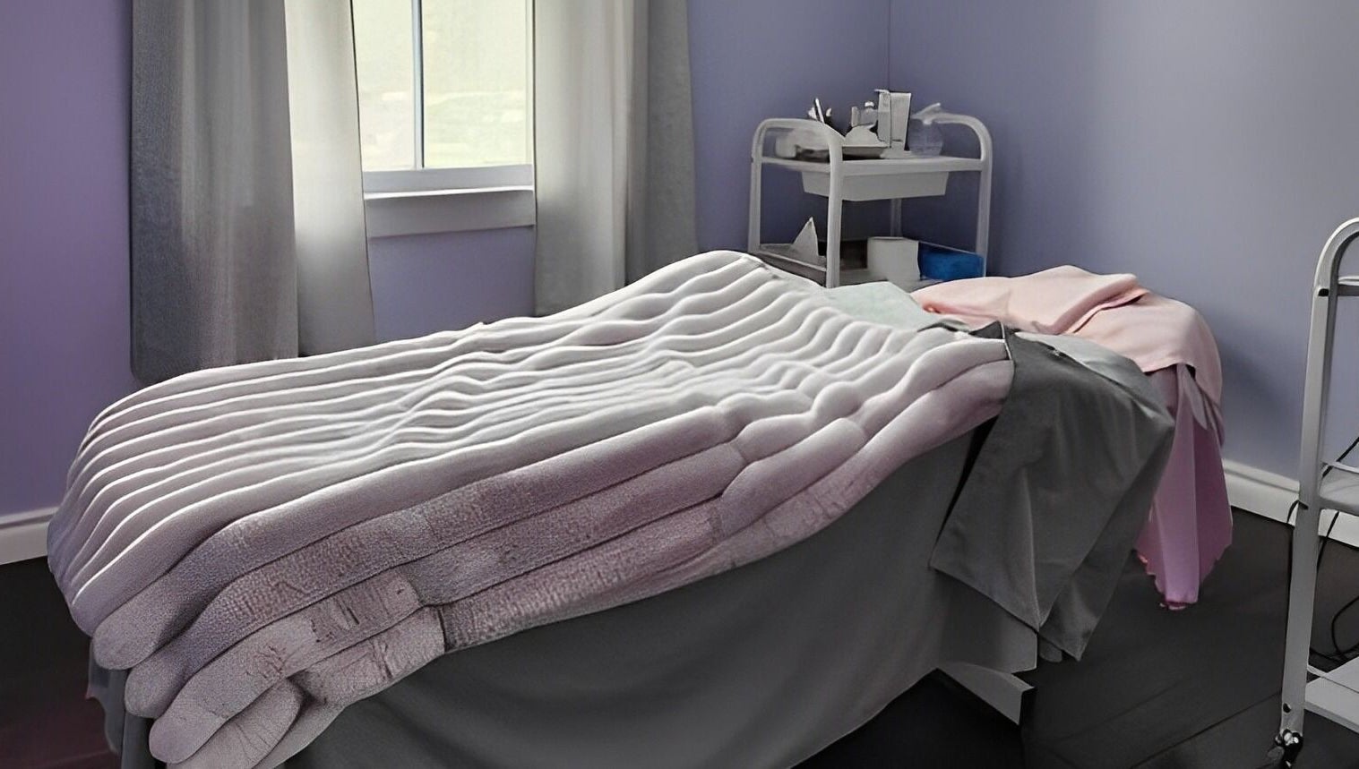 Cozy massage room at Times Aesthetic in Markham, Ontario, CA with plush blankets and soothing decor.