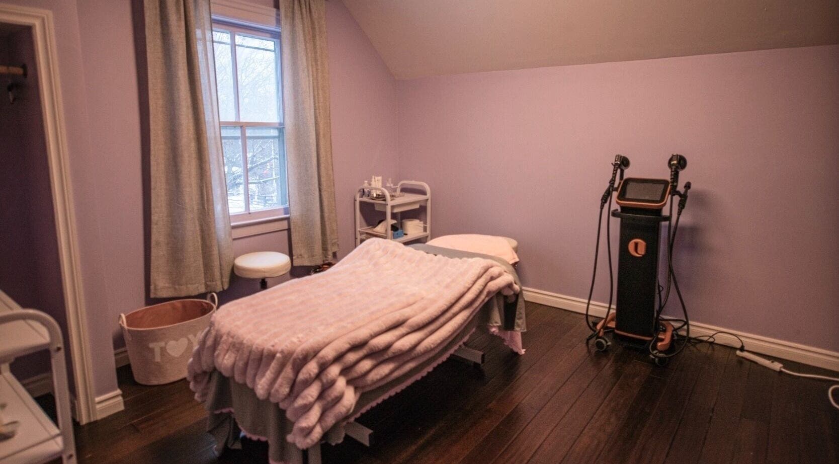 Cozy treatment room at Times Aesthetic, Markham, Ontario, CA with a massage table and soothing decor.