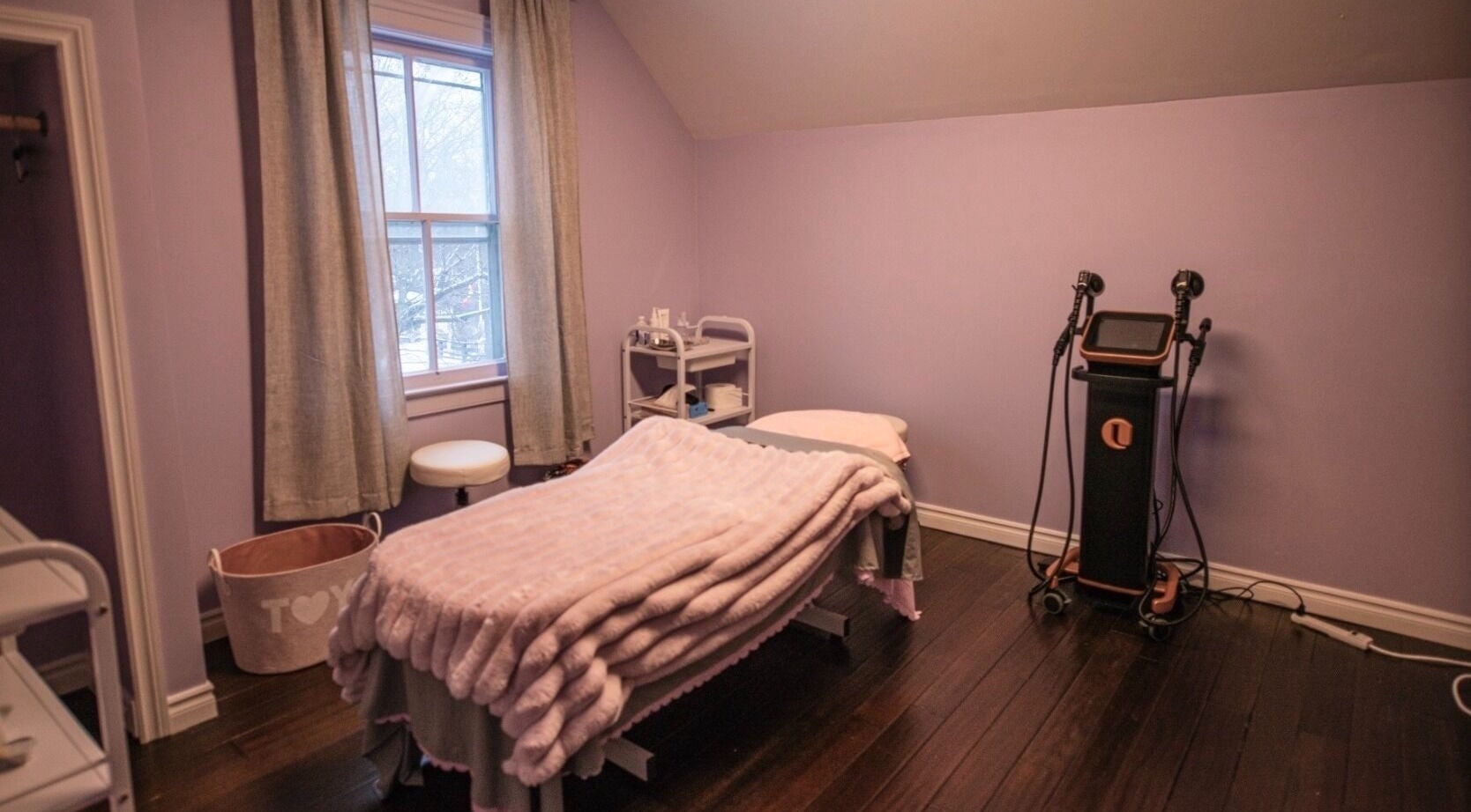 Cozy treatment room at Times Aesthetic, Markham, Ontario, CA with a massage table and soothing decor.