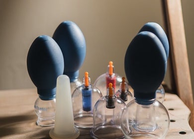 Cupping tools at Cupping It Out in Oranjestad, AW, displayed on a wooden surface.
