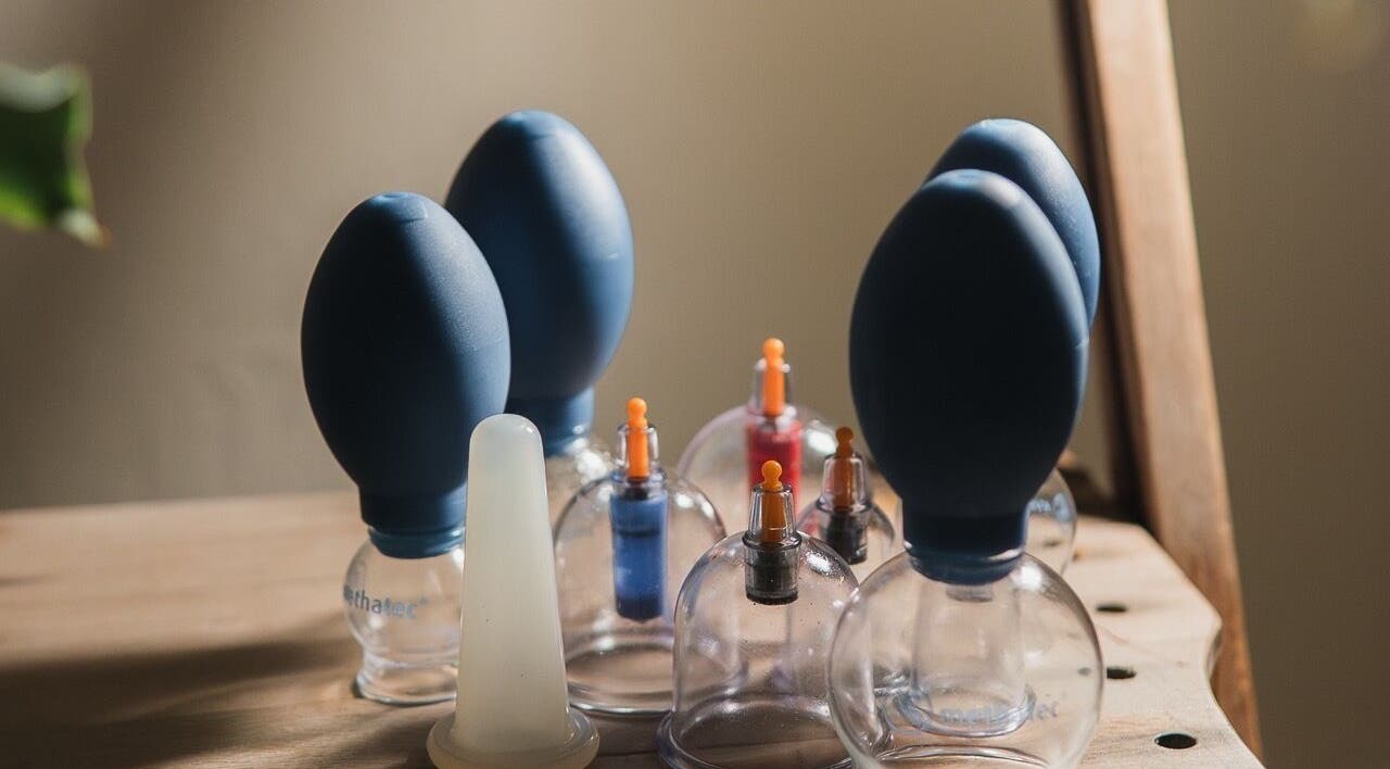 Cupping tools at Cupping It Out in Oranjestad, AW, displayed on a wooden surface.