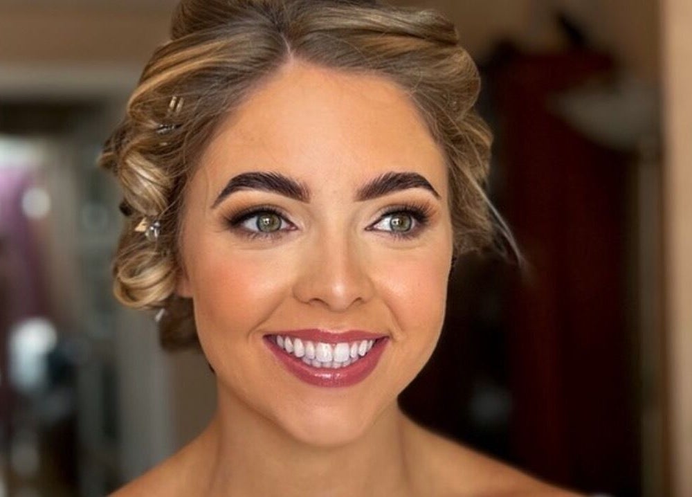 Smiling bride with makeup by Eve Coogan Makeup at Dublin, County Dublin, IE.