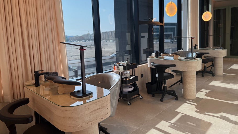 Modern manicure stations at Fayya Beauty Salon & Spa in Al Khobar, Eastern Province, SA with large windows.