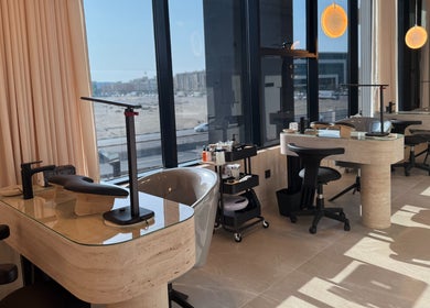 Modern manicure stations at Fayya Beauty Salon & Spa in Al Khobar, Eastern Province, SA with large windows.