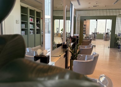Interior of Fayya Beauty Salon & Spa in Al Khobar featuring elegant styling stations and lush greenery.