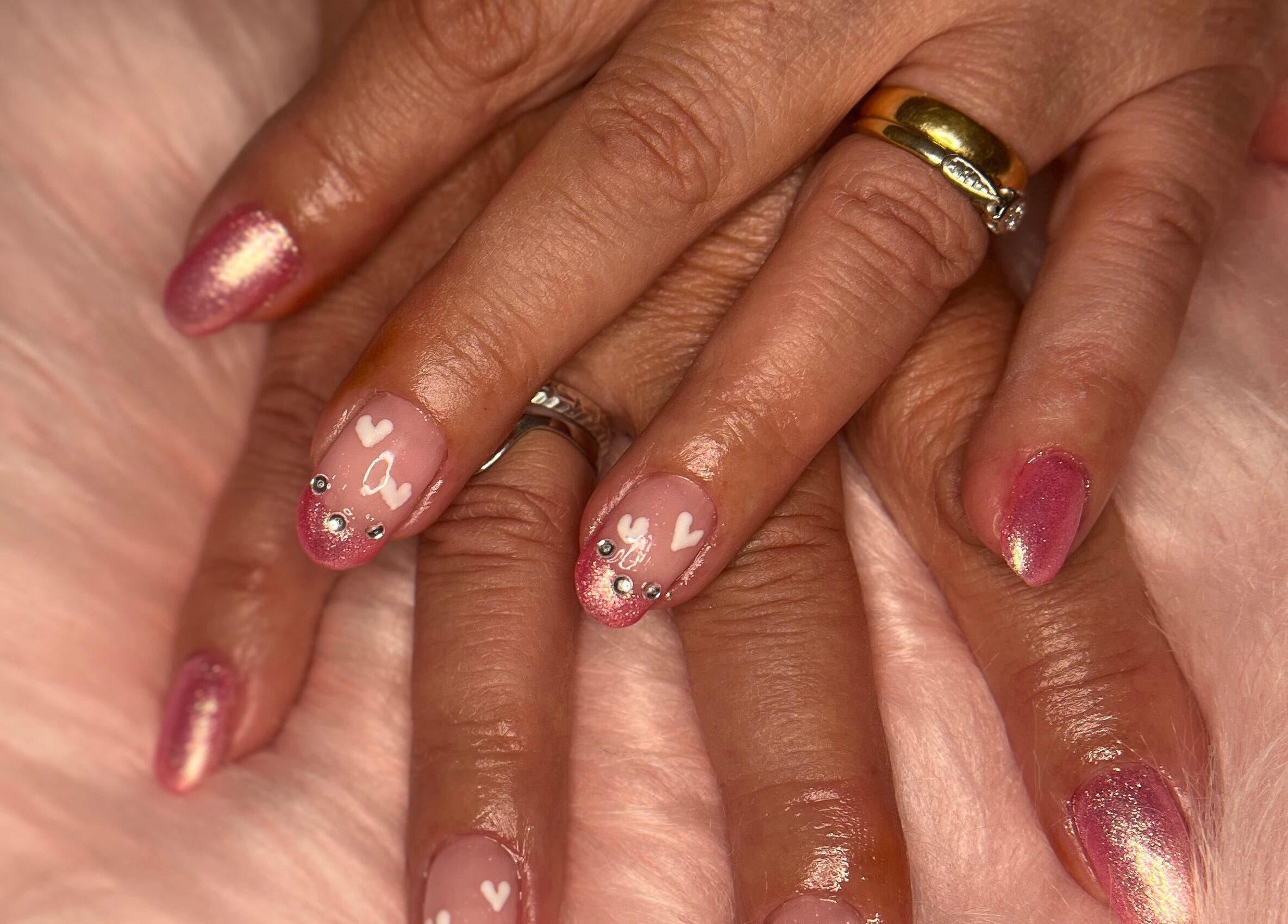 Stunning pink and heart nail art at M & M Nails, Frome, England, GB, showcasing luxury manicure.