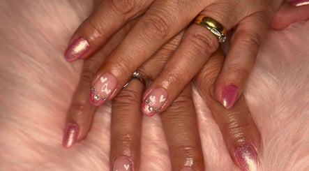 Stunning pink and heart nail art at M & M Nails, Frome, England, GB, showcasing luxury manicure.