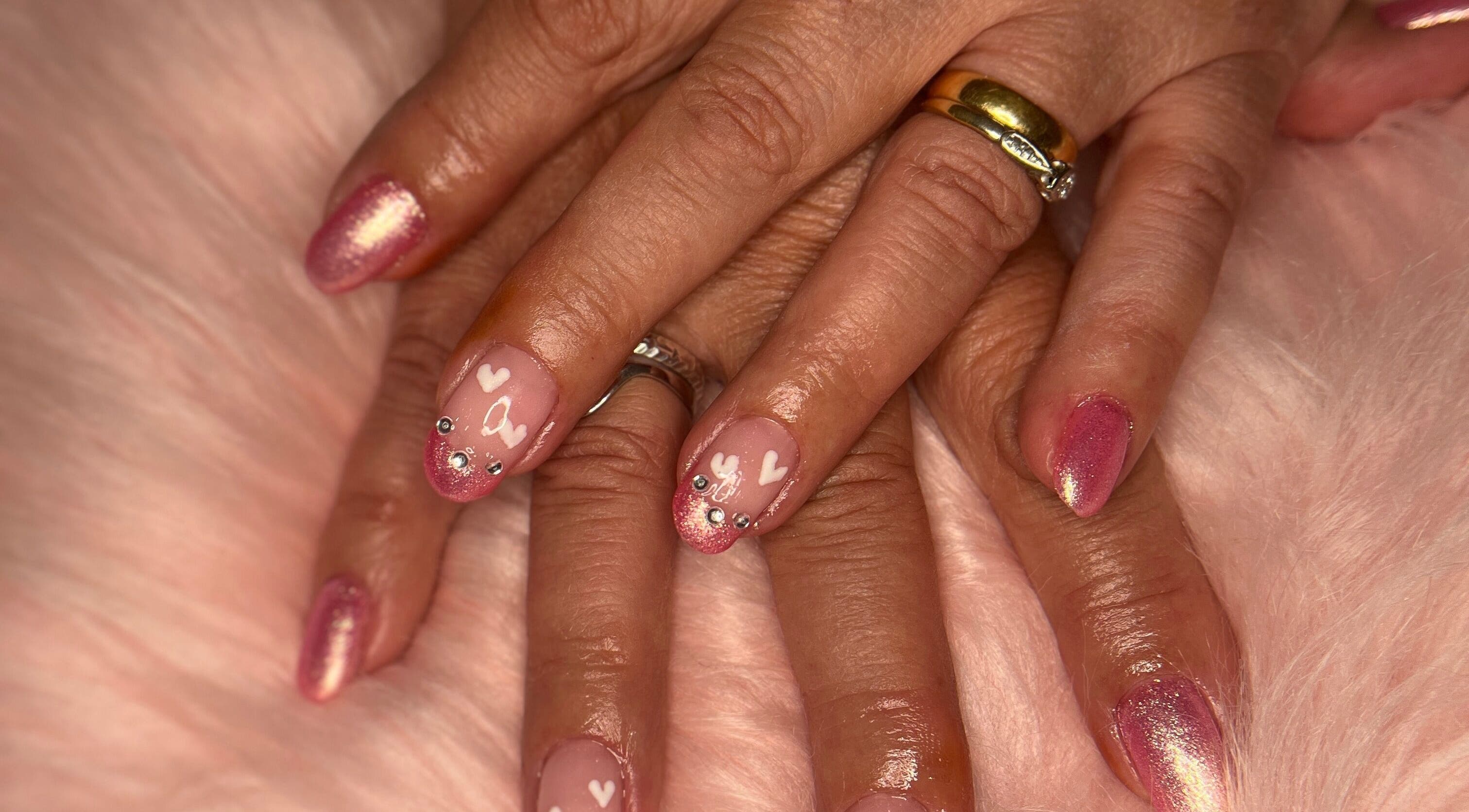 Stunning pink and heart nail art at M & M Nails, Frome, England, GB, showcasing luxury manicure.