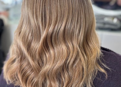 Golden wavy hair styled at Colour Palette, County Meath, County Meath, IE salon. Smooth and elegant finish.
