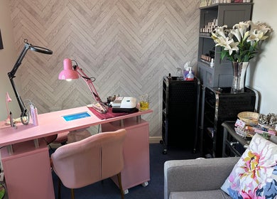 Cozy nail salon setup at Jazz Hands, Ripon, England, GB with pink decor and elegant floral accents.