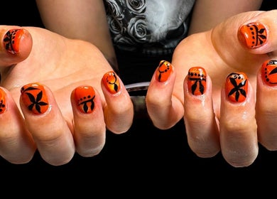 Bold orange and black nail art at Jazz Hands in Ripon, England, GB.