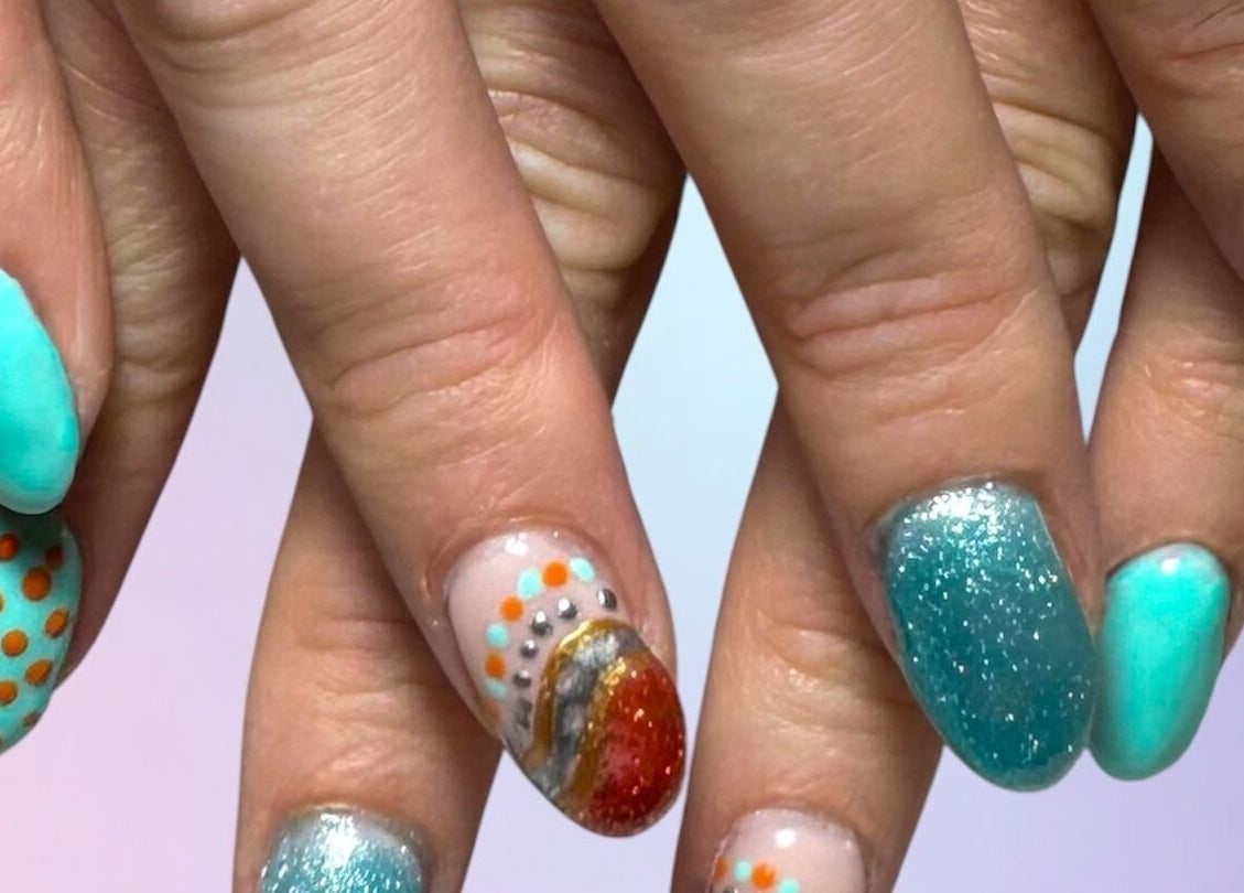 Colorful nail art at Jazz Hands in Ripon, England, GB showcasing turquoise and polka dot designs.