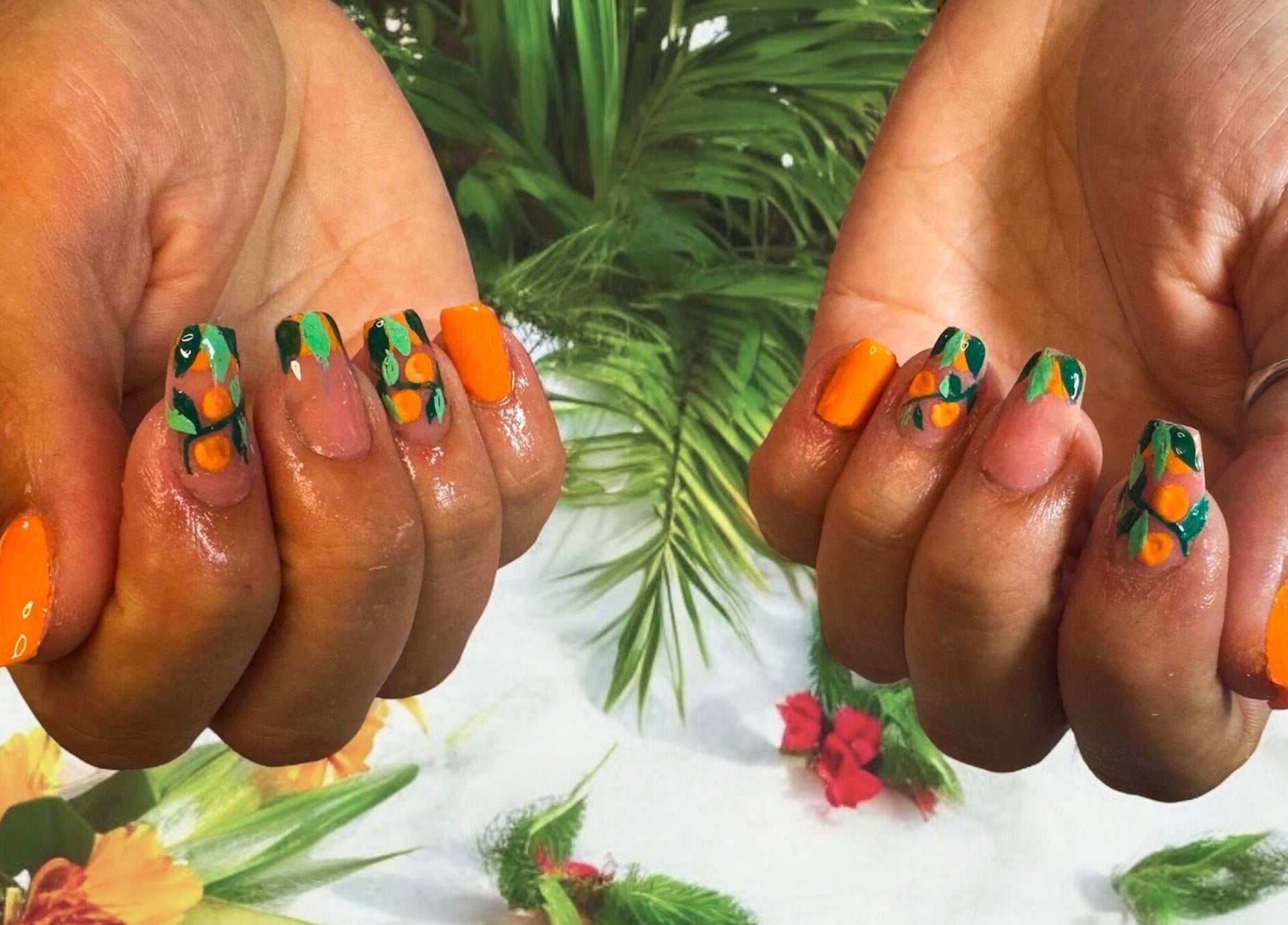 Vibrant tropical nail art at Jazz Hands, Ripon, England, GB. Orange and green designs stand out on polished nails.