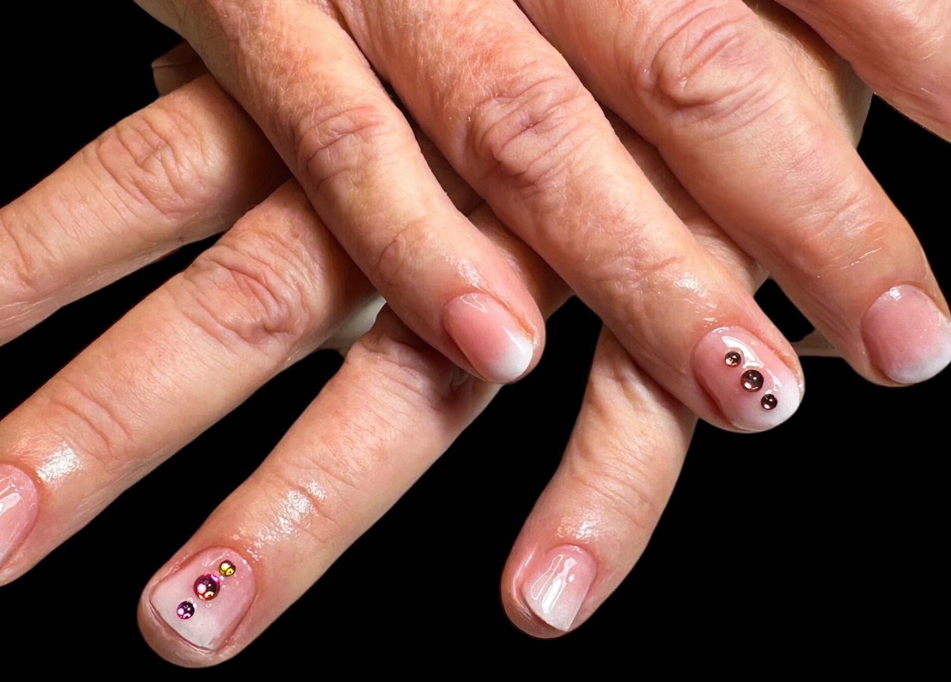Elegant manicured nails at Jazz Hands, Ripon, England, GB showcasing rhinestone accents.