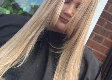 Close-up of a woman with long blonde hair styled at Hair By Aimee, Birmingham, England, GB.