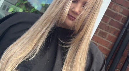 Close-up of a woman with long blonde hair styled at Hair By Aimee, Birmingham, England, GB.