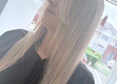Blonde woman with straight hair at Hair By Aimee, Birmingham, England, GB.
