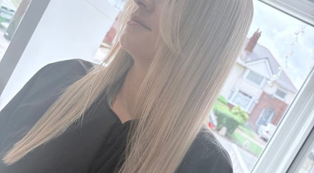 Blonde woman with straight hair at Hair By Aimee, Birmingham, England, GB.