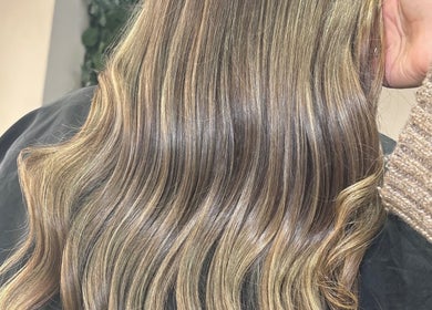 Glossy wavy hair styled by Hair By Aimee in Birmingham, England, GB, showcasing vibrant color and smooth texture.