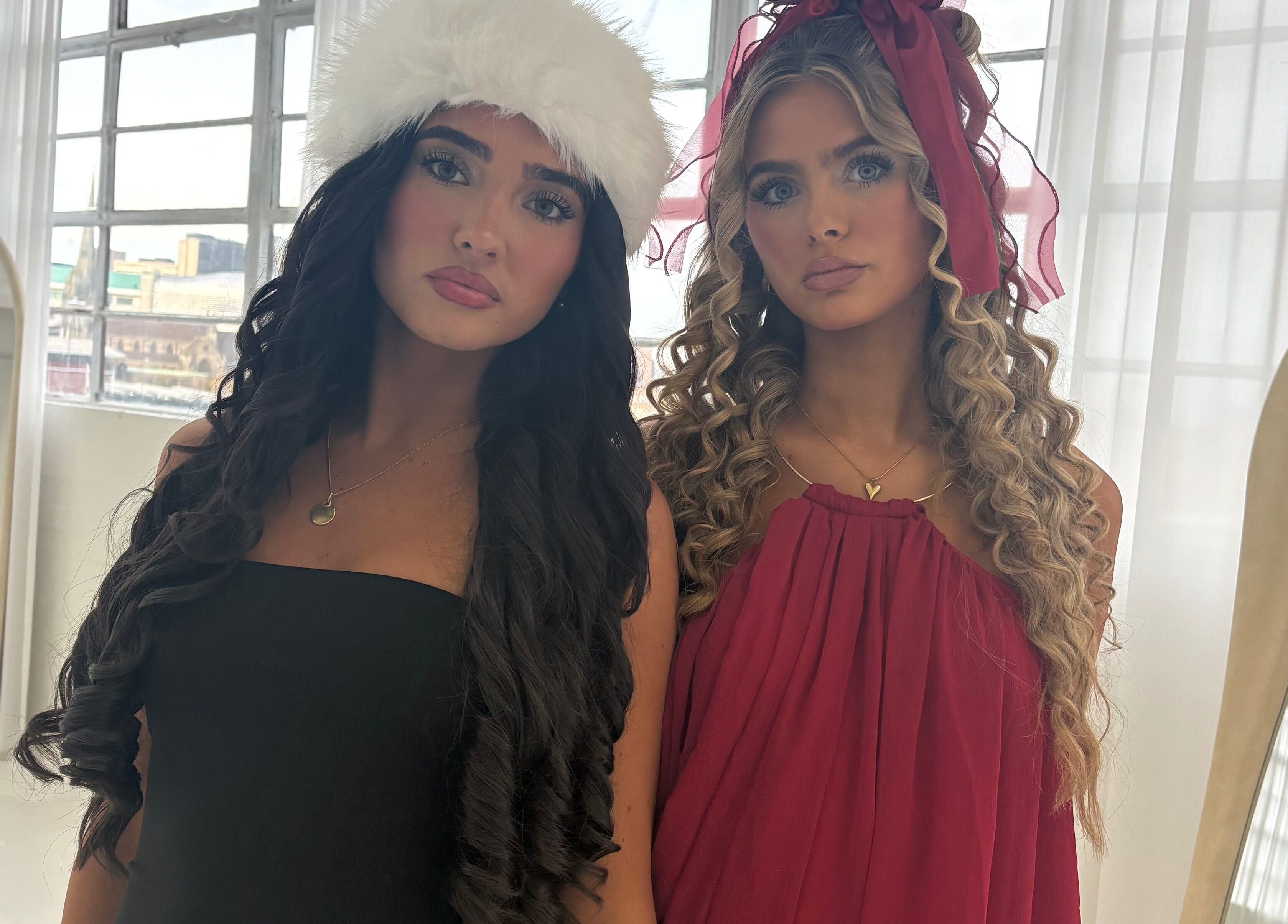 Two women in stylish dresses at Hair By Aimee, Birmingham, England, GB, exemplifying beauty and elegance.