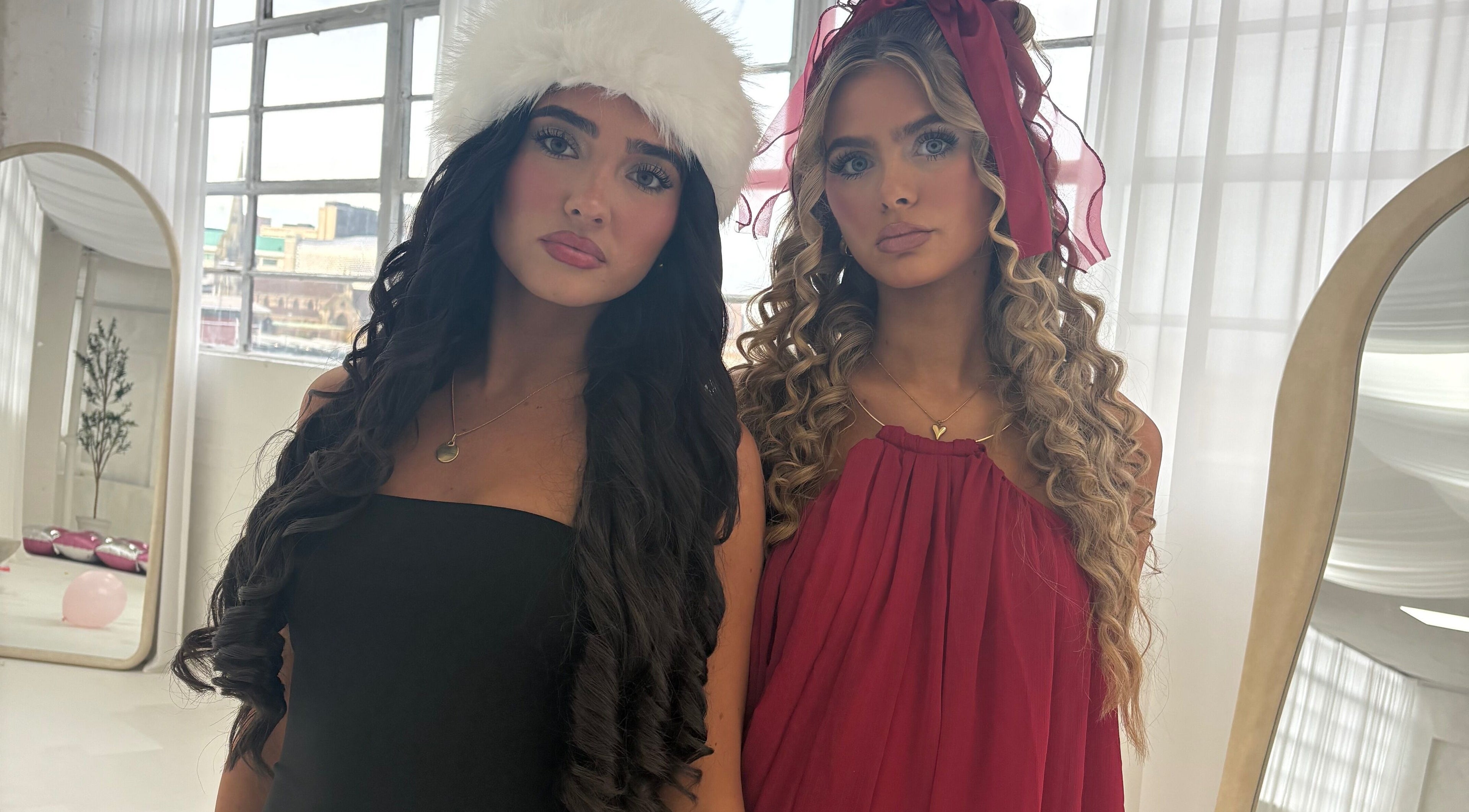 Two women in stylish dresses at Hair By Aimee, Birmingham, England, GB, exemplifying beauty and elegance.