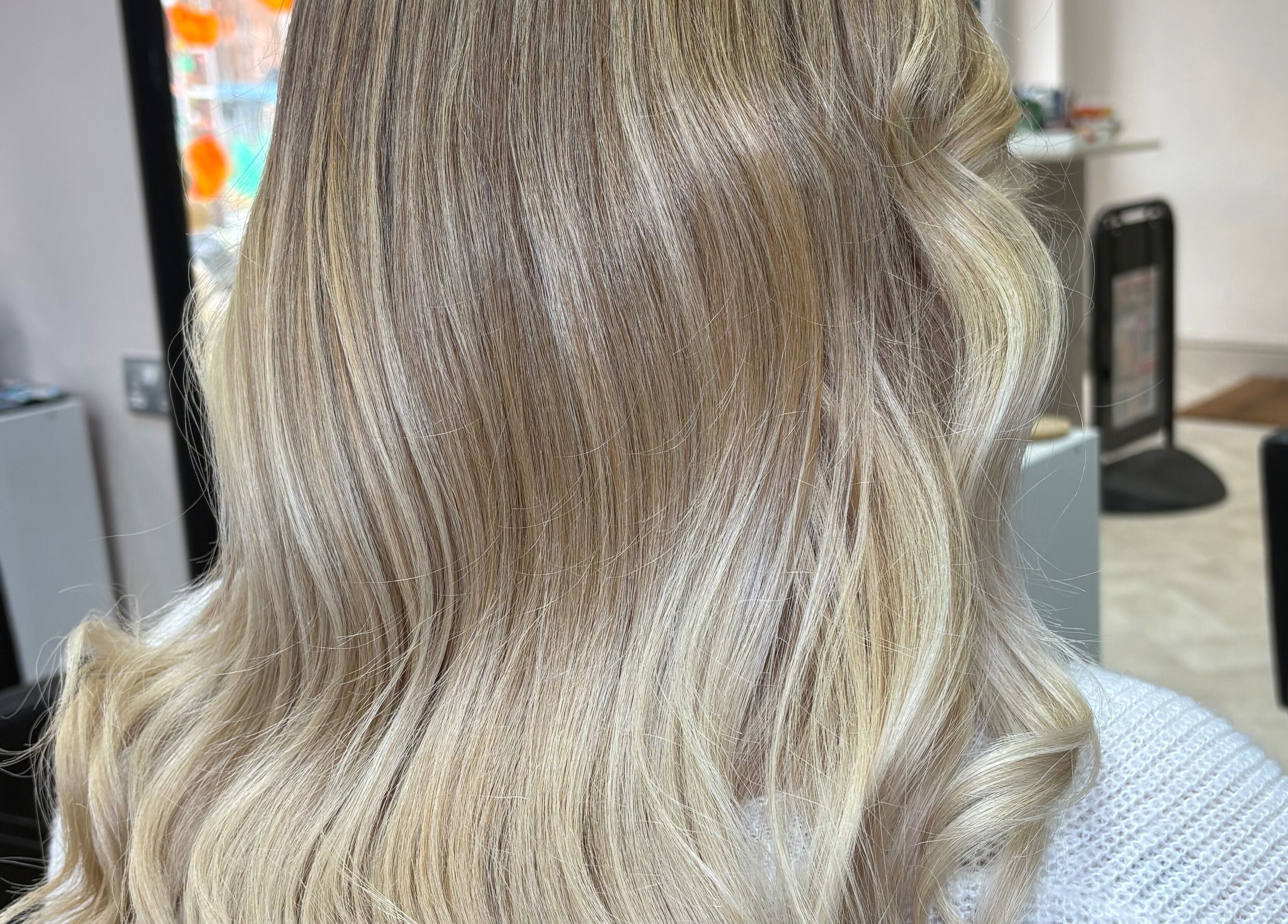Blonde hair styled in waves at Hair By Aimee, Birmingham, England, GB. Elegant and modern hairstyle.