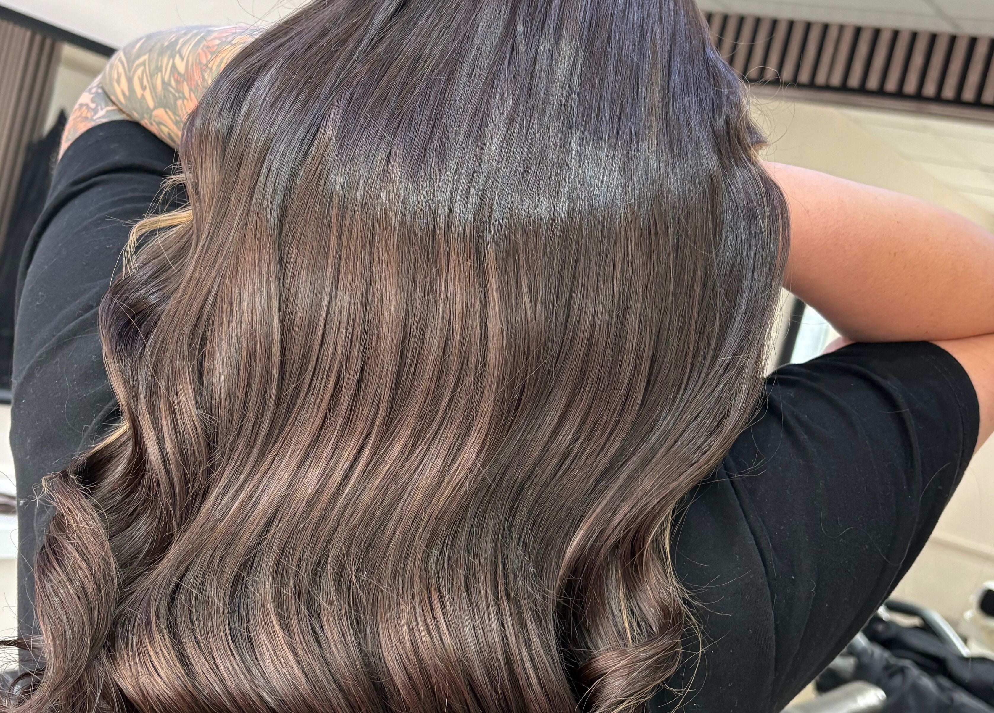 Beautiful brunette waves styled at Hair By Aimee, Birmingham, England, GB, showcasing sleek and glossy texture.