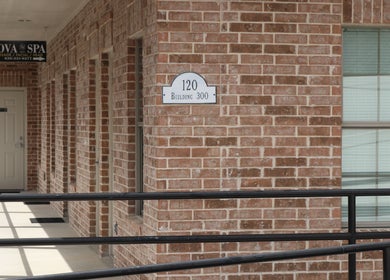 Entrance of Nova Head Spa: Boerne in Boerne, Texas, US showcasing brick exterior and signage.