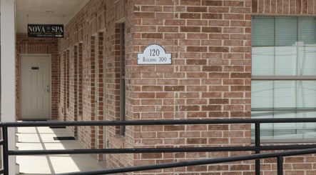 Entrance of Nova Head Spa: Boerne in Boerne, Texas, US showcasing brick exterior and signage.