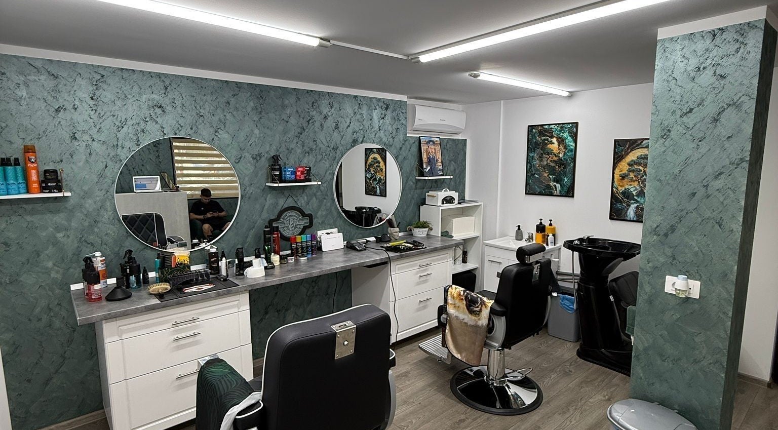 Interior modern al Barber Craft GH din Gura Humorului, Județul Suceava, RO, cu scaune de coafor și oglinzi rotunde.