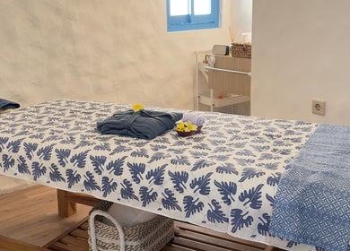Relaxing massage table setup at Blue Cave Spa, Bali, Bali, ID with floral decor and soft lighting.