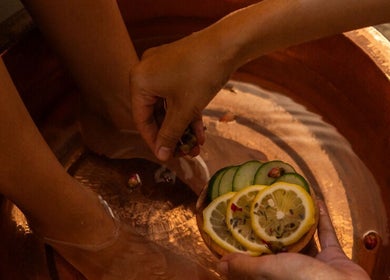Relaxing foot soak with citrus slices at Blue Cave Spa, Bali, Bali, ID, offering rejuvenating wellness treatments.