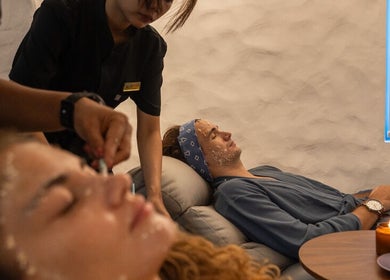 Clients enjoying facial treatments at Blue Cave Spa, Bali, Bali, ID. Relaxing ambiance with candles and tea.
