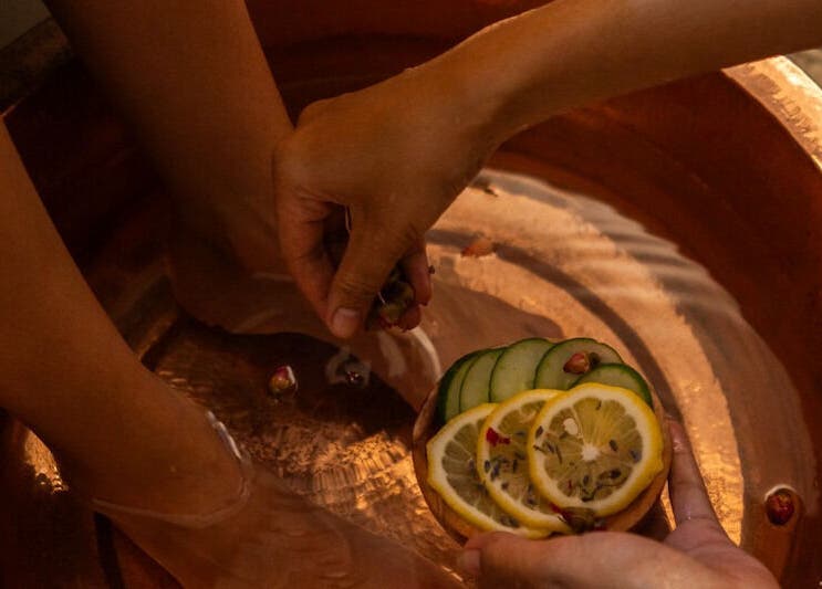 Foot soak with citrus slices at Blue Cave Spa, Bali, Bali, ID, enhancing relaxation and rejuvenation.