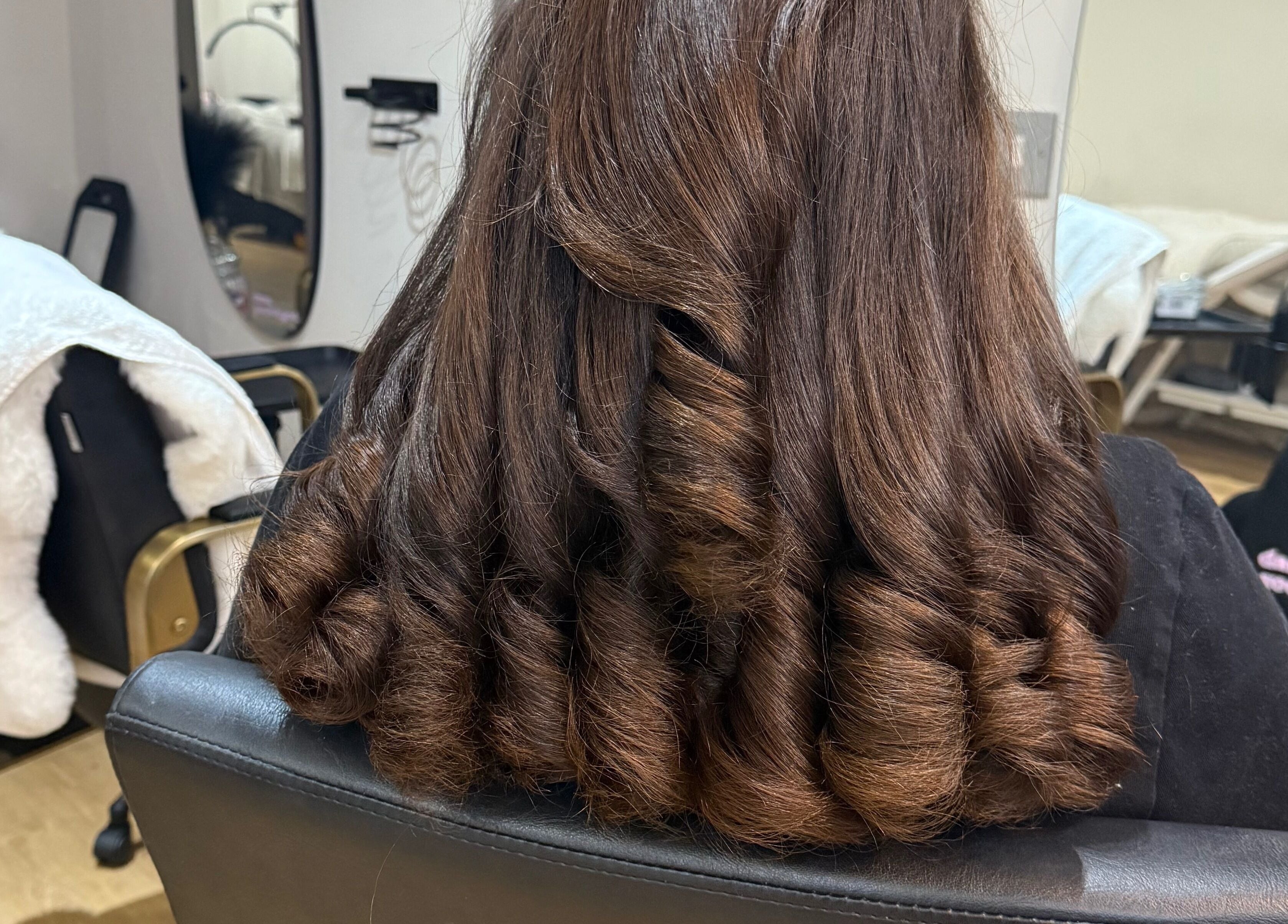 Styled brown curls at Dolled Up, Bournemouth, England, GB beauty salon.