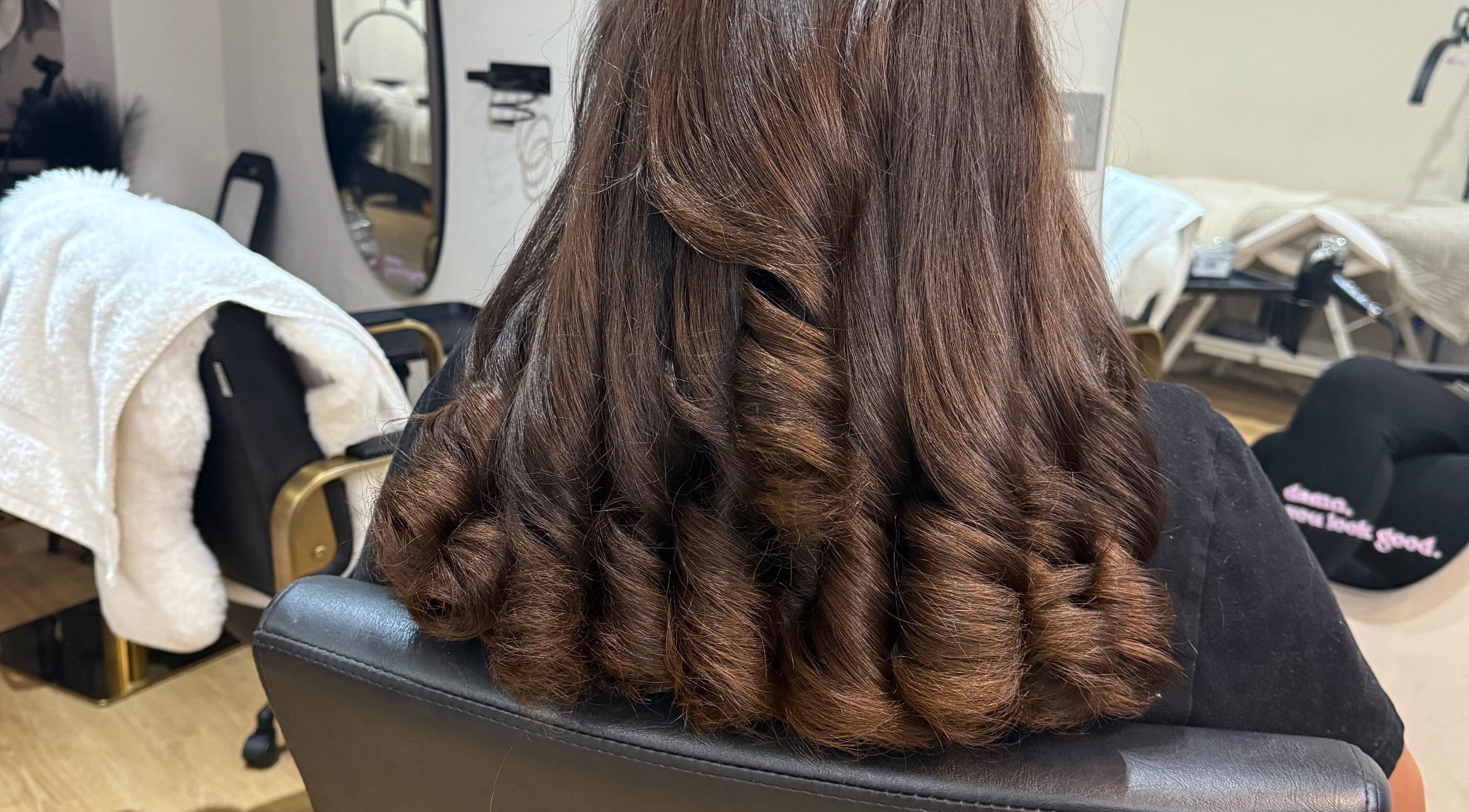 Styled brown curls at Dolled Up, Bournemouth, England, GB beauty salon.