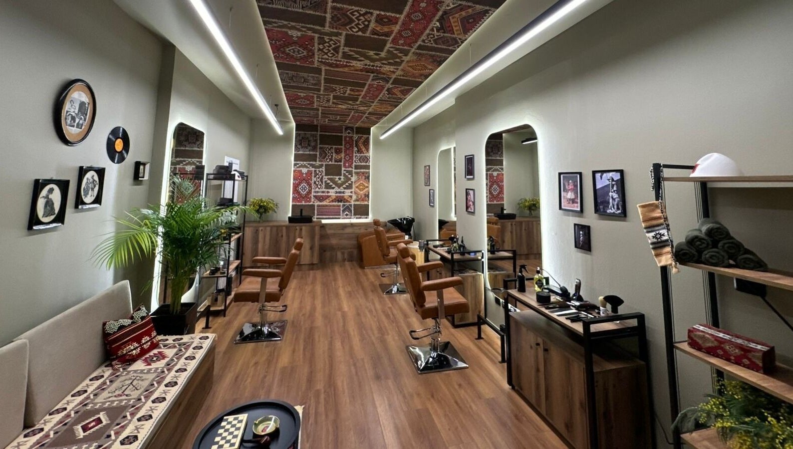 Cozy interior of Oda Barber Shop in Tiranë, Qarku I Tiranës, AL featuring elegant decor and barber chairs.