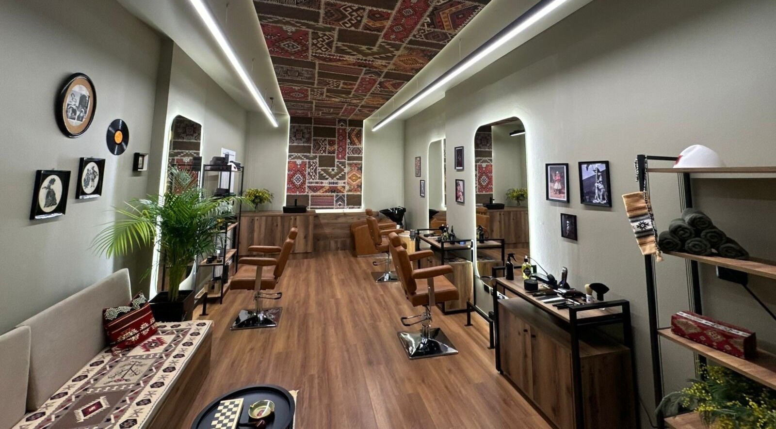Cozy interior of Oda Barber Shop in Tiranë, Qarku I Tiranës, AL featuring elegant decor and barber chairs.