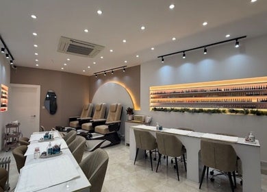 Modern interior of Exquisique Nails & Beauty salon in Epsom, England, GB with elegant nail stations and cozy chairs.