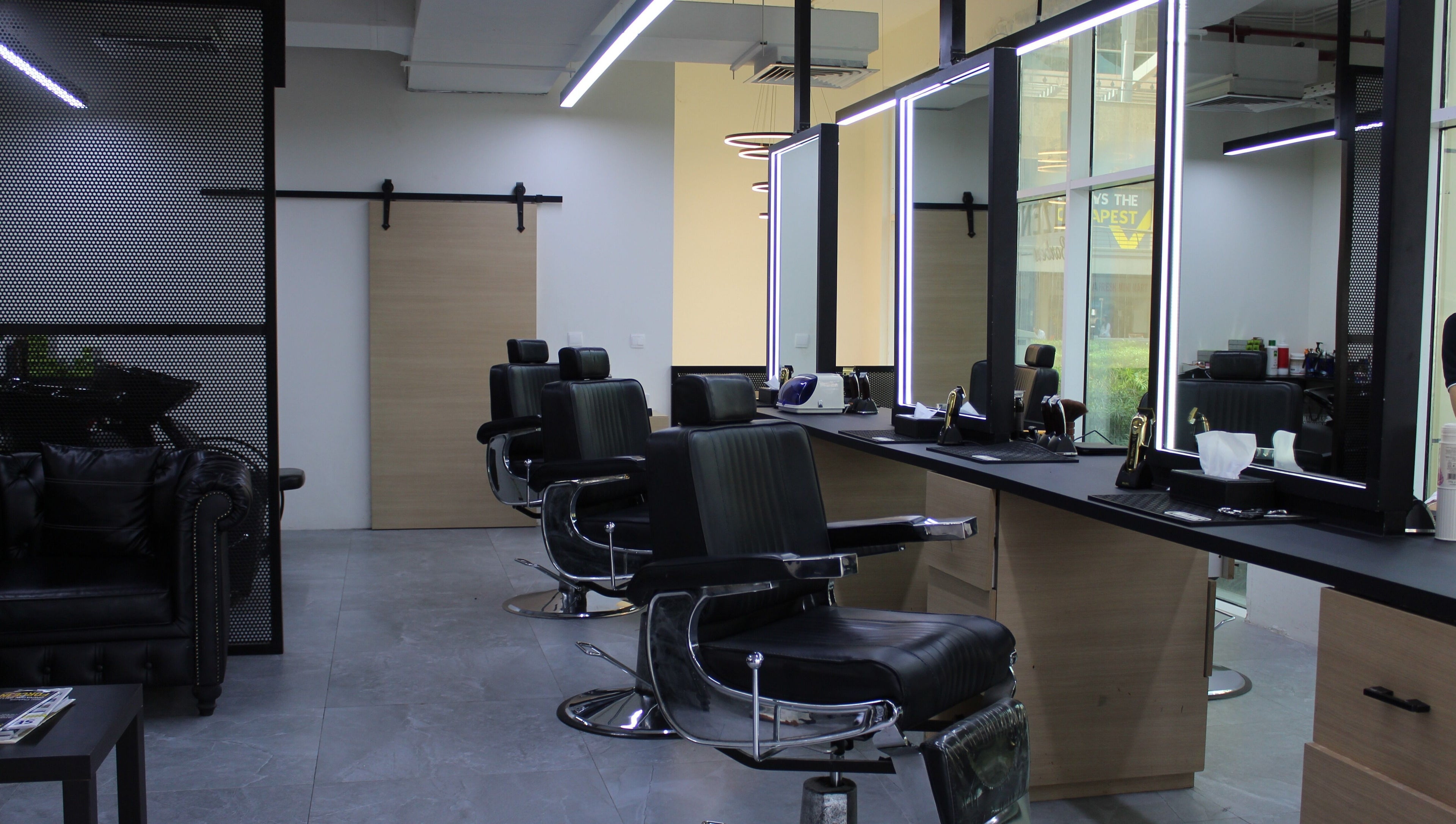 Elegant interior of Kaizen Barbershop in Dubai, Dubai, AE with modern barber chairs and mirrors.