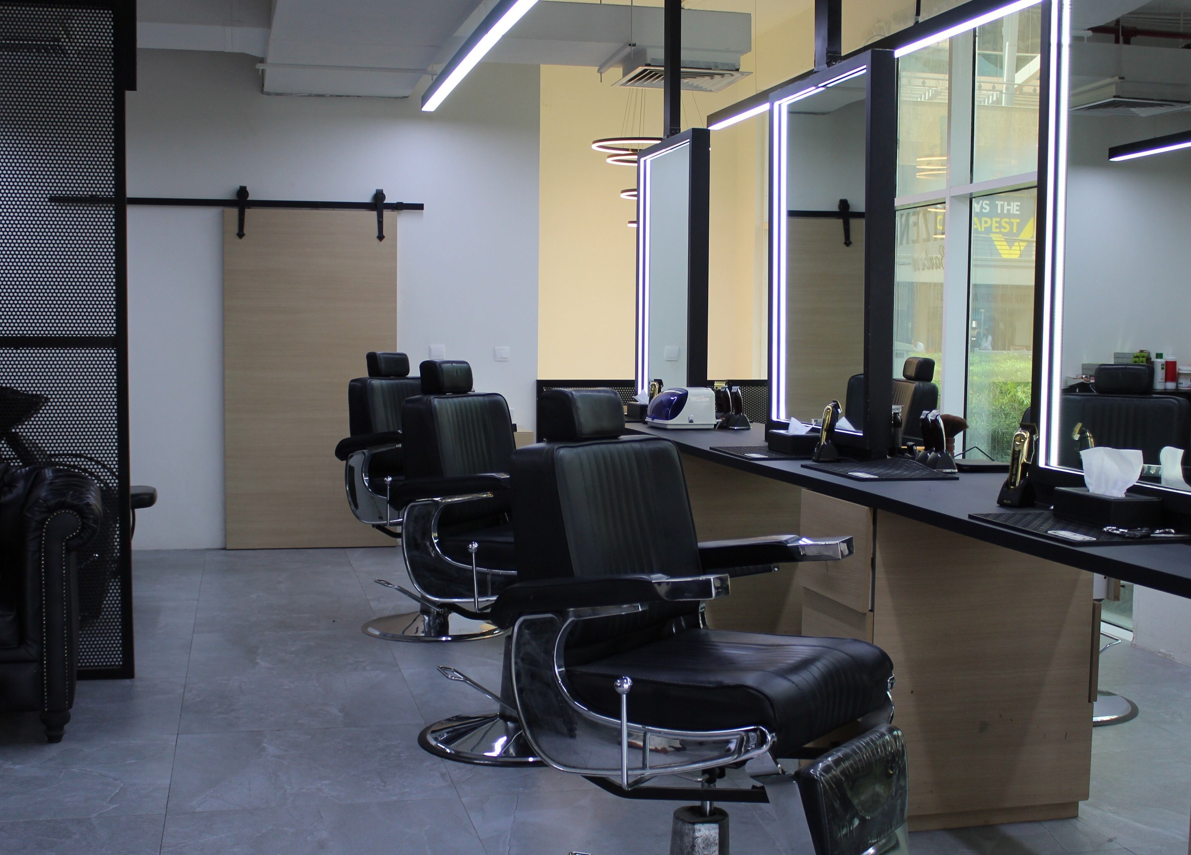 Elegant interior of Kaizen Barbershop in Dubai, Dubai, AE with modern barber chairs and mirrors.