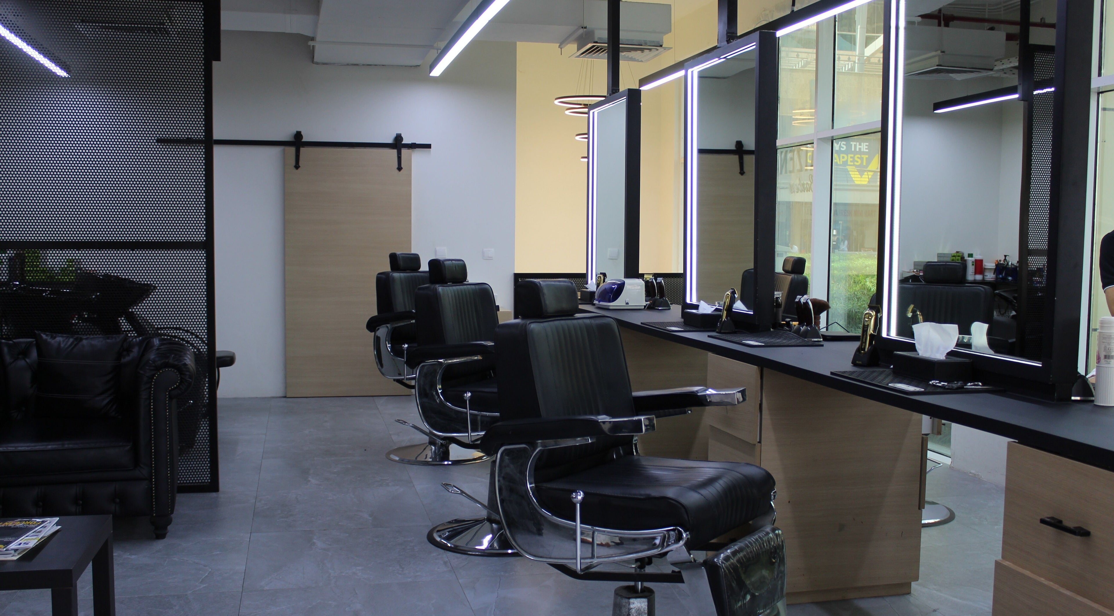 Elegant interior of Kaizen Barbershop in Dubai, Dubai, AE with modern barber chairs and mirrors.