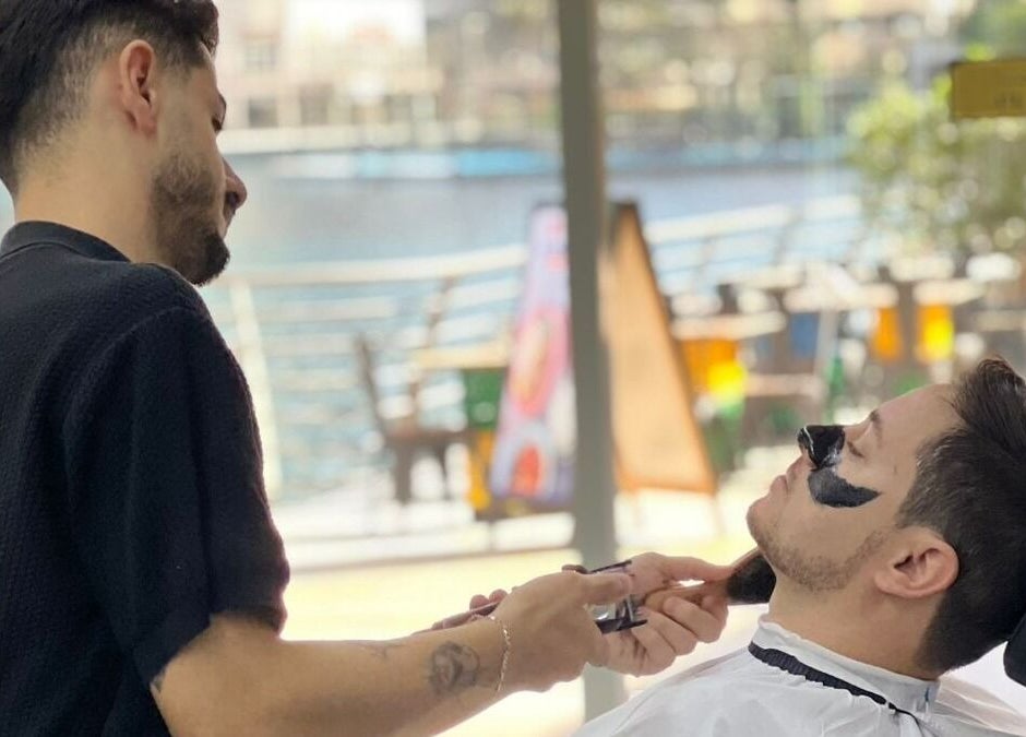 Professional barber grooming a client at Kaizen Barbershop in Dubai, Dubai, AE.