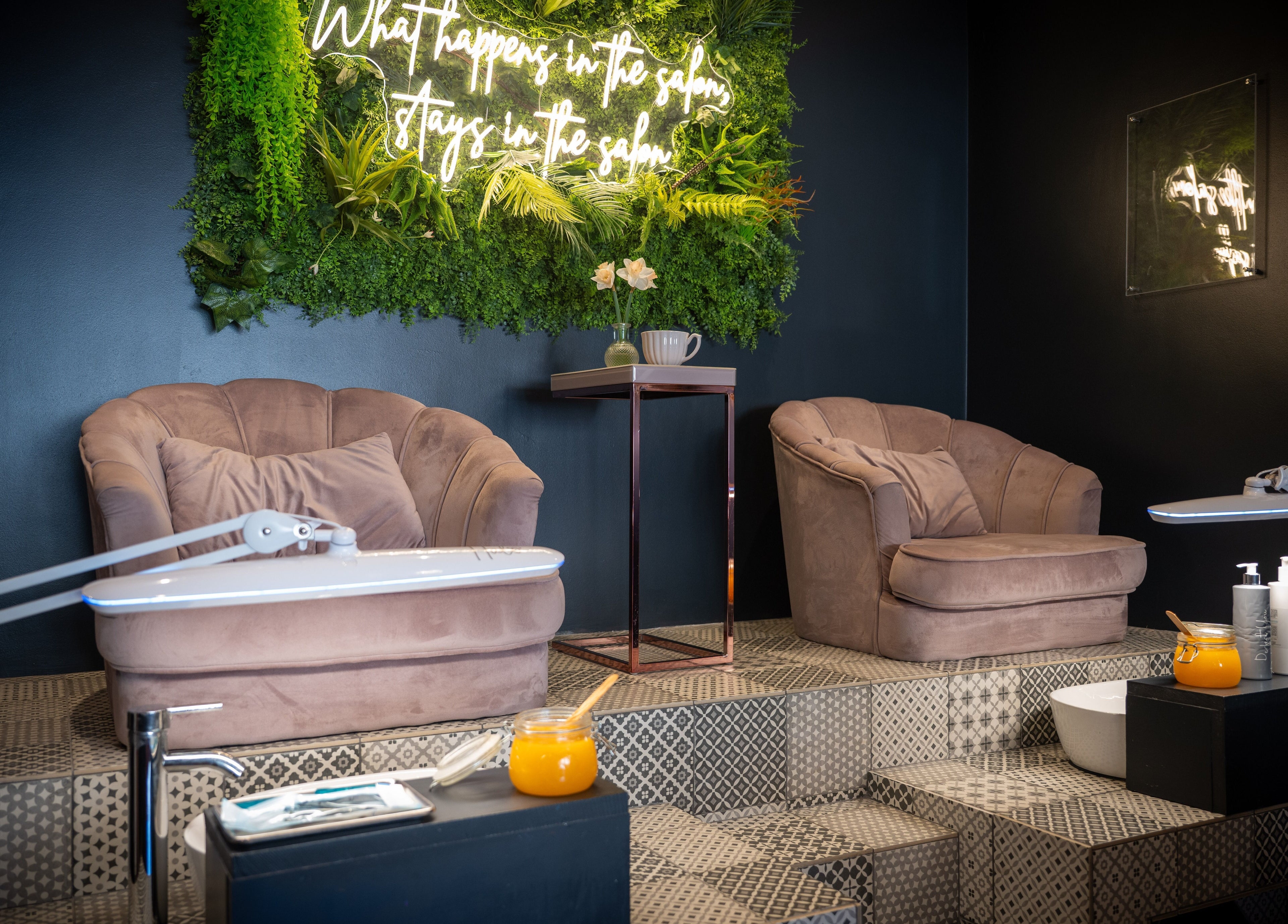 Luxurious spa chairs at Perfect You, Teddington, England, GB, with a vibrant green wall feature.