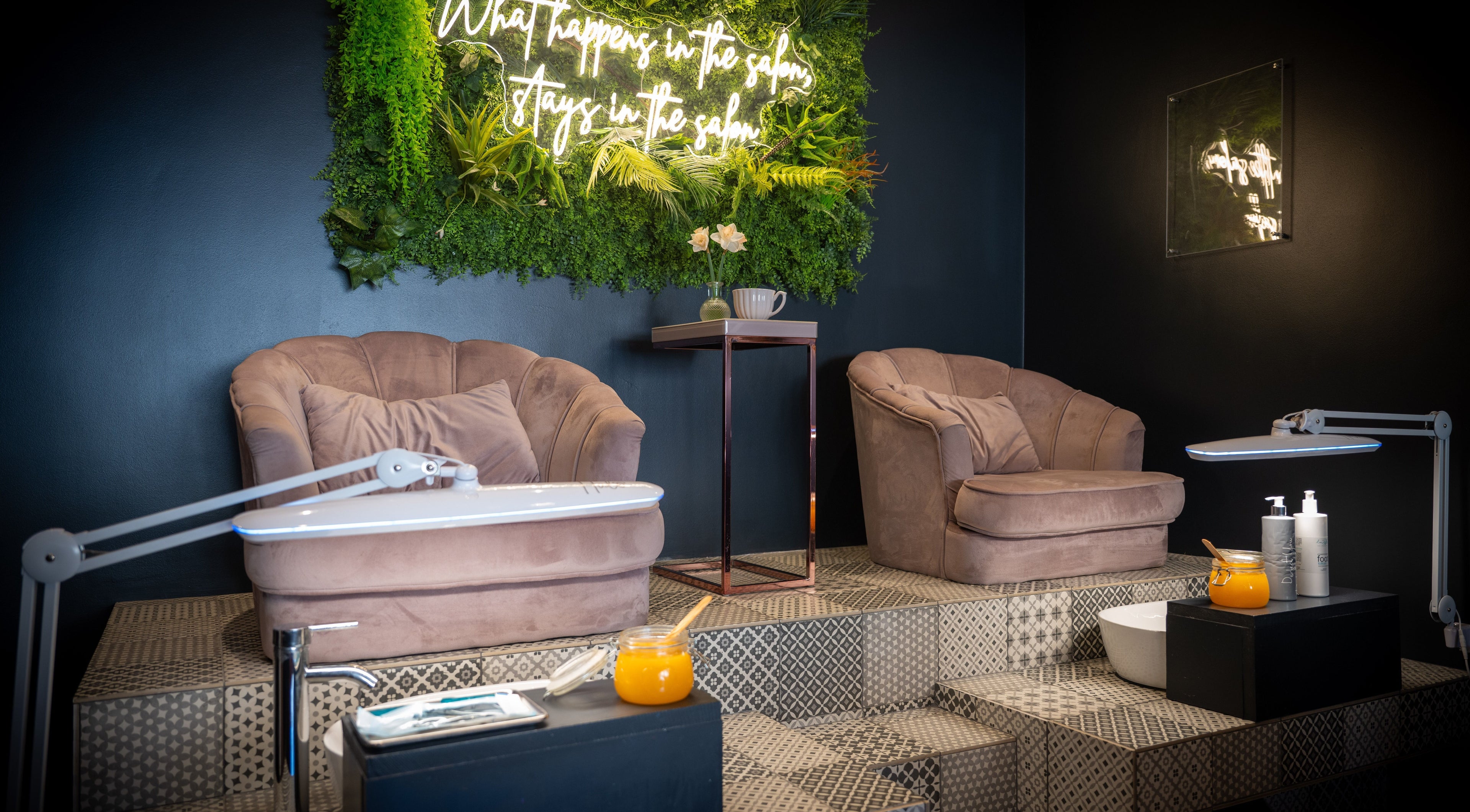 Luxurious spa chairs at Perfect You, Teddington, England, GB, with a vibrant green wall feature.