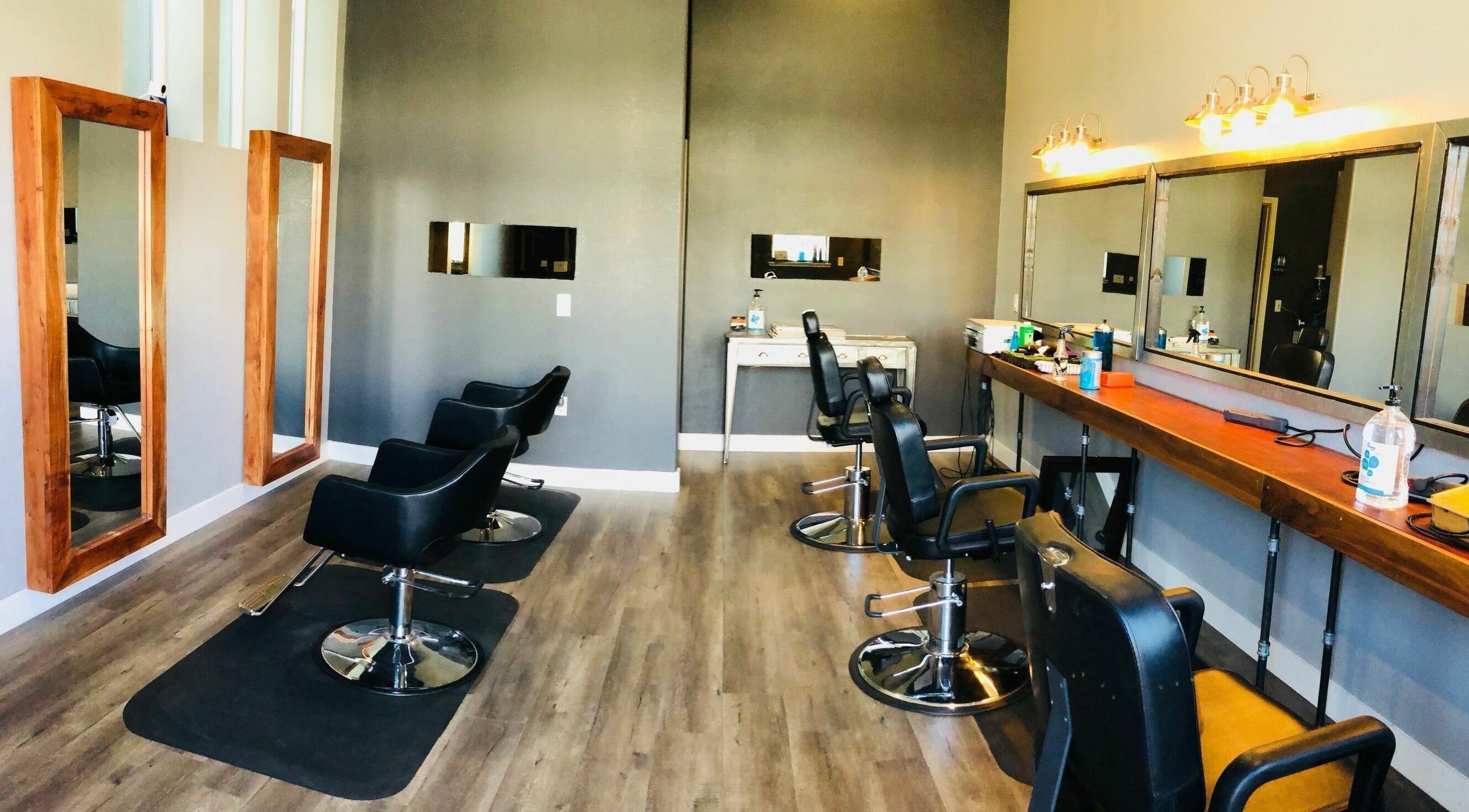 Modern salon interior at Dappers and Dolls in Milpitas, California, US with sleek styling chairs and large mirrors.